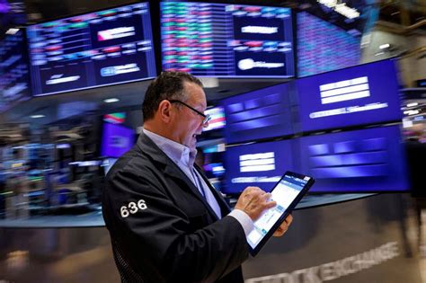 Dow notches record high close after upbeat economic data.